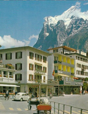 Quaint Alpine village scene with colorful buildings and majestic mountains, portraying a serene, inviting atmosphere for travel and leisure.
