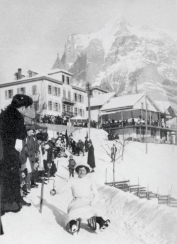 Vintage black and white photo of a bustling ski resort, capturing a cheerful scene with guests in winter attire, ideal for showcasing historical travel and leisure.