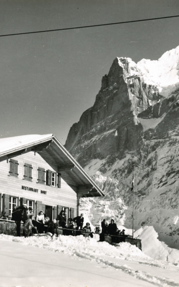 Vintage ski resort scene with a chairlift passing over a snow-covered chalet, exuding an adventurous yet serene alpine mood.