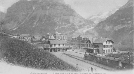 Historic Grindelwald train station and hotel in a serene mountain setting, evoking a nostalgic and peaceful ambiance for travel enthusiasts.