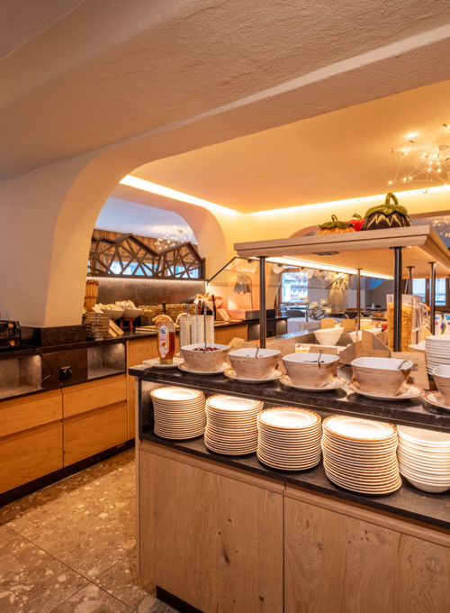 Cozy buffet area with warm lighting and wooden furnishings, inviting hospitality industry vibes for a comforting meal experience.