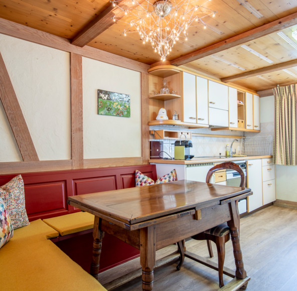 Cozy dining nook with wooden accents and warm lighting, creating a homely and inviting space perfect for culinary settings.