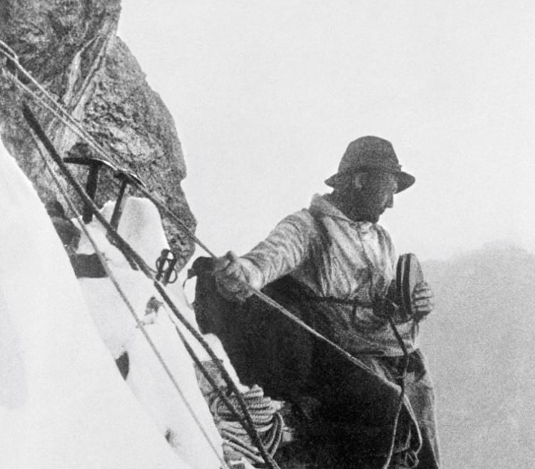 Monochrome image of a climber on a snowy mountain, instilling a sense of adventure and resilience for outdoor enthusiasts.