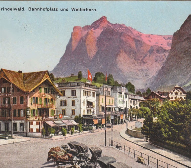 Vintage postcard of Grindelwald, featuring quaint, colorful buildings and the striking Wetterhorn peak, evoking nostalgia and the charm of Alpine tourism.