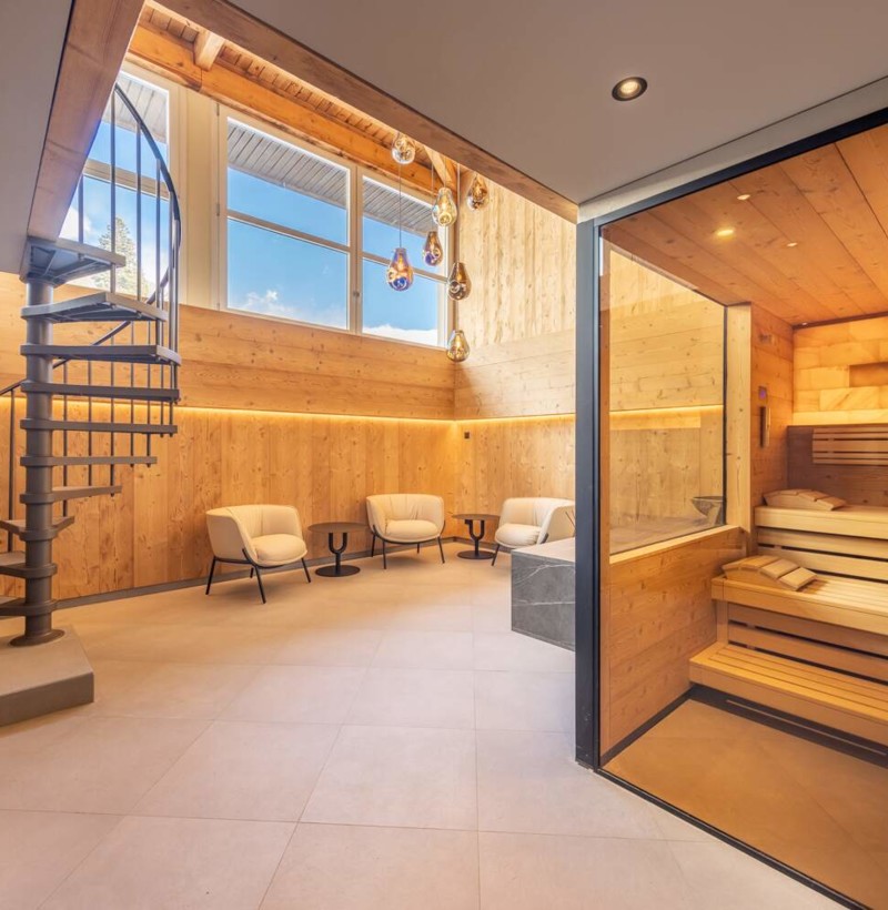 Warm wooden sauna with glass doors, enhanced by serene lighting, creates a soothing ambiance for wellness retreats.