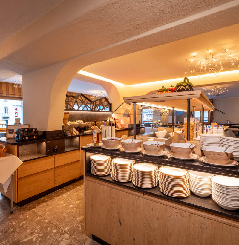 Cozy buffet area with warm lighting and wooden furnishings, inviting hospitality industry vibes for a comforting meal experience.