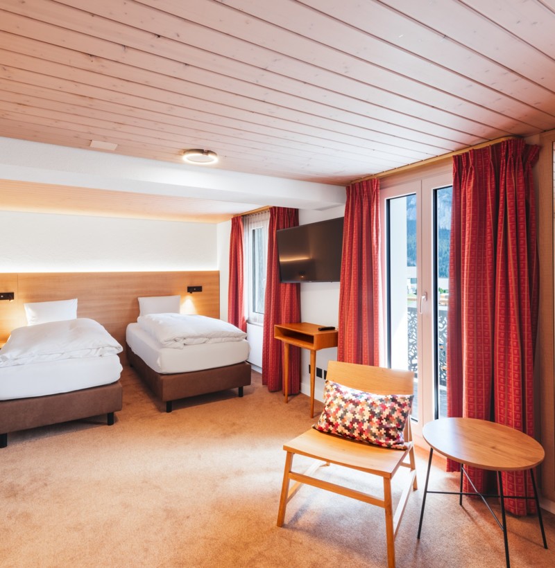 Cozy hotel room with wooden accents and warm lighting, creating a welcoming atmosphere ideal for travel and leisure.