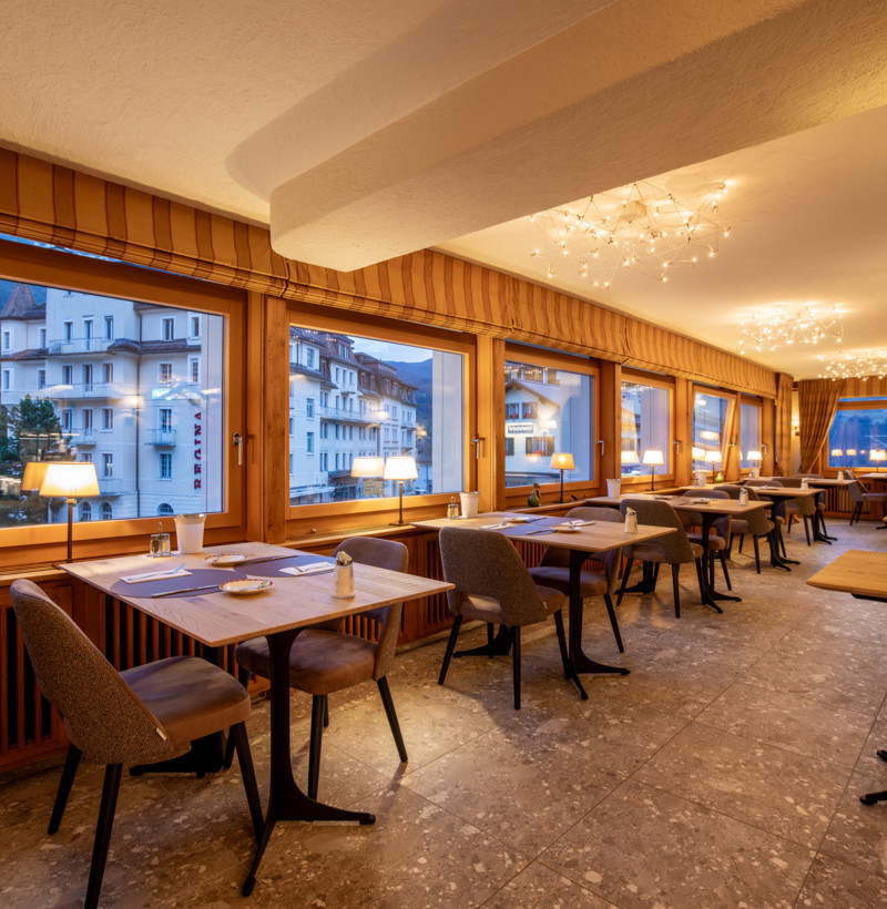 Cozy restaurant interior with warm lighting and wooden accents, exuding a welcoming ambiance for dining enthusiasts.