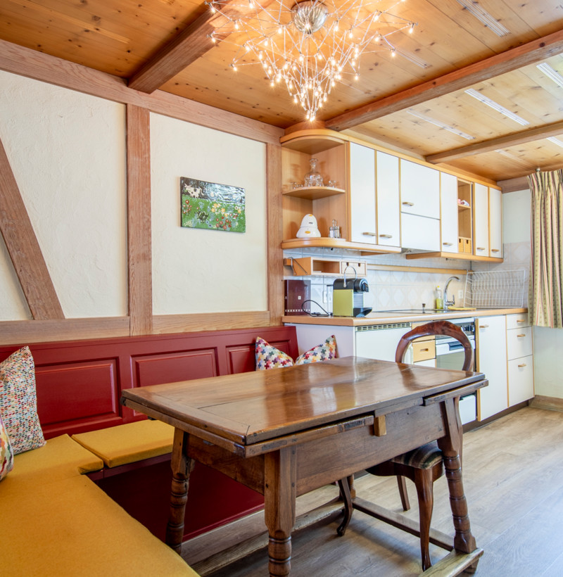 Cozy dining nook with wooden accents and warm lighting, creating a homely and inviting space perfect for culinary settings.