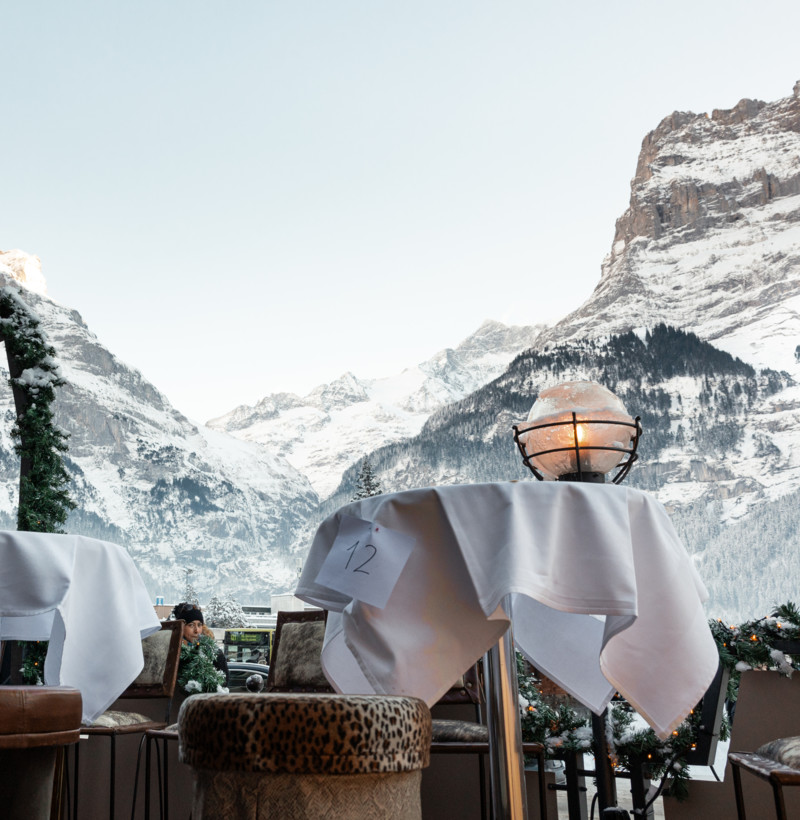 Toasting with sparkling champagne, hands clink crystal flutes against a backdrop of festive, twinkling Christmas lights, radiating warmth and celebration ideal for holiday marketing.