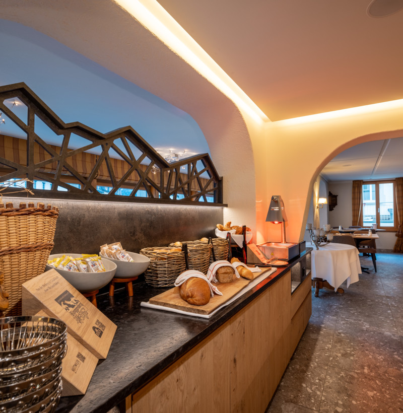 Warmly lit buffet area with wooden accents and a cozy ambiance, ideal for catering and hospitality settings.