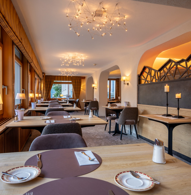 Cozy restaurant interior with warm lighting and elegant wooden accents, creating a welcoming ambiance for dining experiences.